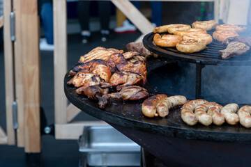 Grilling a variety of meats on an outdoor barbecue in warm weather