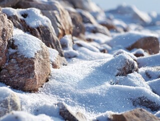 Shimmering Close-Up of Freshly Fallen Snow Covering Rocks with Sparkling Ice Crystals Under Bright Sunlight