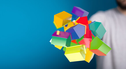 Concept image of hand holding a cluster of geometric house miniatures representing real estate,...