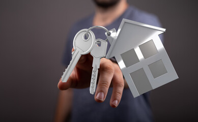 Image of a person holding keys with a house cutout. Represents buying, owning, and selling a home.  Ideal for real estate and financial concepts