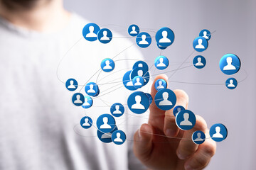 Concept of social networking or online connection in business. Hand touching icons symbolizing the network and community. Concept of communicati