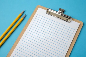 Clipboard with paper and pencils