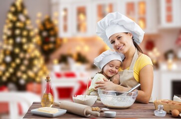Happy young mother with child cooking at home kitchen