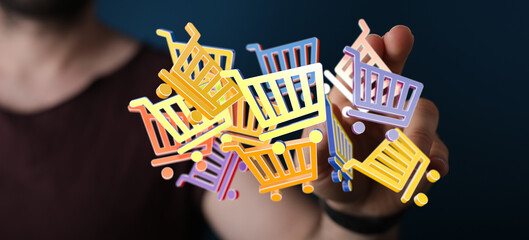 Hand holding floating shopping carts, representing online shopping, sales and consumerism. Perfect...