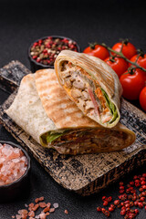Shawarma with chicken or beef, tortilla roll, and vegetables. Shawarma with meat