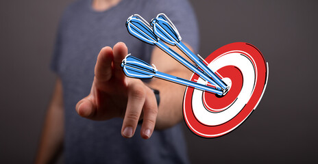 Person interacting with a target with arrows, representing achievement and business strategy. Concept of hitting the mark, success and focus. © vegefox.com