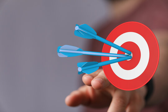 Concept of success, reaching goals and strategy with arrows hitting bullseye. Focus on precision, accuracy, and achievement. Business target con
