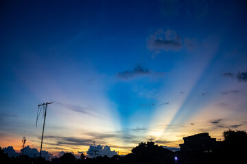 sunset sky with rays of light and cloud in the evening.