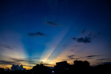 sunset sky with rays of light and cloud in the evening.