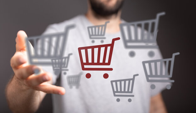 Conceptual image of a person presenting shopping carts, representing online shopping, sales and e-commerce. Perfect for illustrating buying, dea