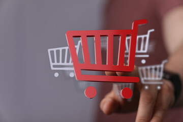 Digitally rendered shopping cart icons symbolizing online shopping, e-commerce, and digital...