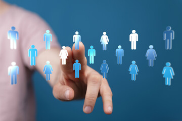 Hand touching digital people symbols representing teamwork, diversity, and community connection. Human interaction concept.