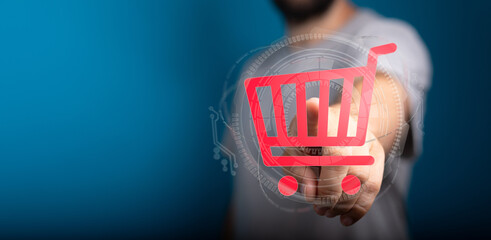 A person's hand interacting with a digital shopping cart icon. Represents online shopping,...