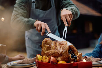 Close up of man carving Thanksgiving turkey.