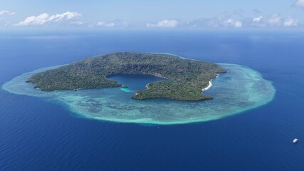 The remote island of Pulau Terbang is found in the midst of the Banda Sea, Indonesia. Surrounded by a massive coral reef this beautiful island is home to a diverse array of marine biodiversity.