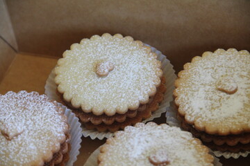 Traditional Maizena alfajores filled with dulce de leche and dusted with powdered sugar—a beloved Latin American sweet treat.
