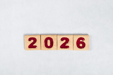 New Year 2026. Square cookies with red marmalade filling in the shape of the festive numbers 2026. White background. Top view
