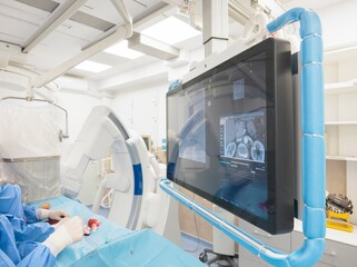 In a modern operating room, a medical team prepares to use innovative microspheres for targeted therapy