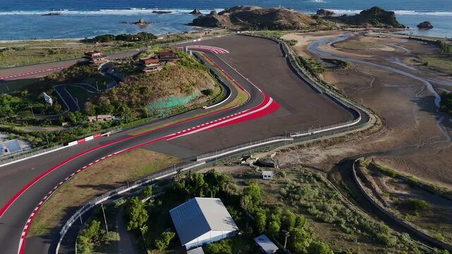 Expansive aerial footage showcasing the intricate turns and beautiful coastal scenery of the Mandalika International Street Circuit, a premier destination for motorsport enthusiasts in Indonesia