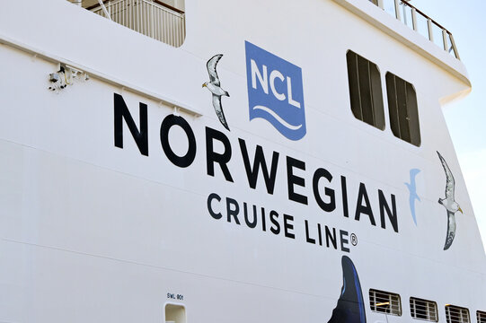 Acapulco, Mexico - 17 January 2024: Low angle view of the side of a large cruise ship operated by NCL Norwegian Cruise Line.