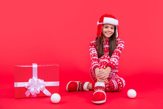 merry xmas. happy santa teen girl with xmas present sit in studio. teen girl with xmas santa present - Powered by Adobe