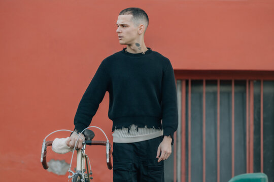 young man with bicycle on the street