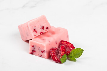 Raspberry candy with pieces of freeze-dried raspberries. Close-up	
