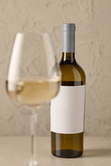 wine bottle and defocused glass of white wine