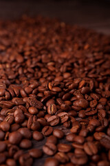close-up view of a rich pile of roasted coffee beans showcasing their glossy texture and deep brown hues, evoking the aroma and warmth of freshly brewed coffee in an inviting ambiance, unroasted