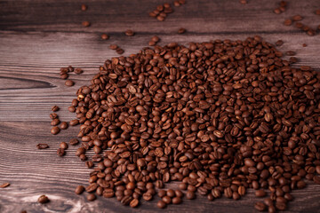 close-up view of richly toned coffee beans scattered across a rustic wooden surface, capturing the texture and warmth of freshly roasted aroma in a cozy setting, espresso, latte, decaf, artisan