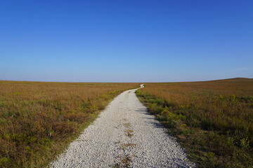 Dirt road  across open grassland