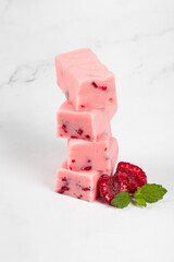 Vegan Raspberry candy with pieces of freeze-dried raspberries. Close-up