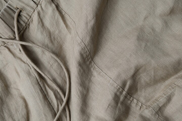 Close-up of natural linen pants with waistband, minimalist fashion and sustainable clothing concept
