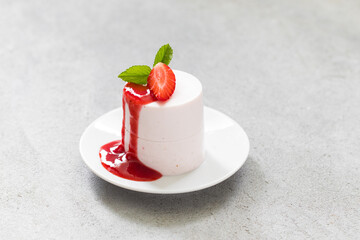 Vanilla cream pudding, Panna Cotta cylindrical shape. With Strawberry sauce. Close up