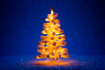 Illuminated artificial tree with glowing lights in snowy night christmas