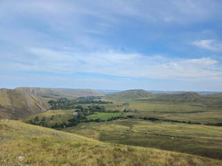 Fototapeta premium nature of Russia. Vast valley landscape viewed from elevated vantage point. freedom, boundless horizons, and nature's majestic untouched beauty from above.