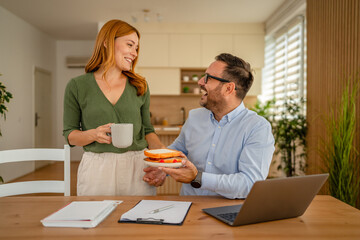Partner bringing lunch to remote working man