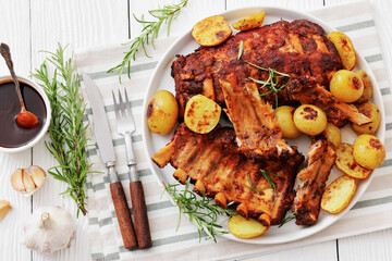 bbq baby pork ribs with potatoes, fresh rosemary