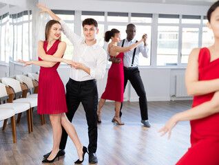 Fototapeta premium Young man and young woman dance couple tango dance in studio