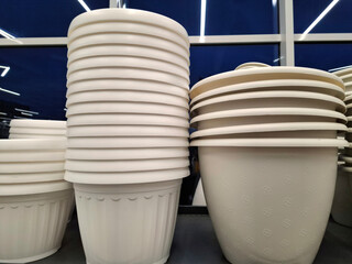 White plastic flower pots are sold at flower shop