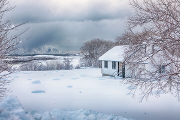 Dramatic nowy winter scene of  small cemetery on Lofoten Islands near Stamsund.