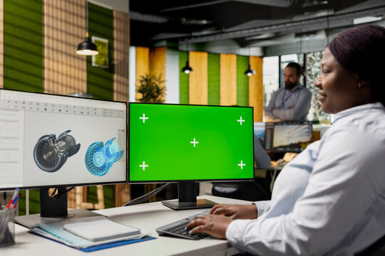 Engineer uses green screen mockup computer to analyze turbine components, improving sustainability metrics. Woman at work looks at turbine parts on chroma key PC to cut emissions and make clean energy