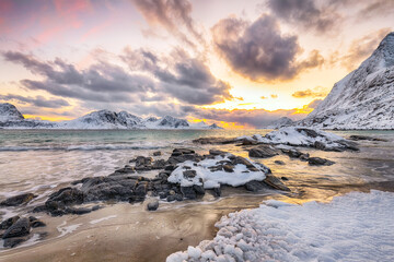 Amazing winter view of Vik beach during sunset with lots of snow  and snowy  mountain peaks near Leknes.