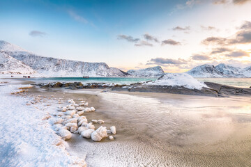 Stunning winter scenery with Haukland beach during sunset and snowy  mountain peaks near Leknes.