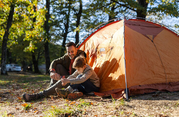 Boy tying shoelaces in camp