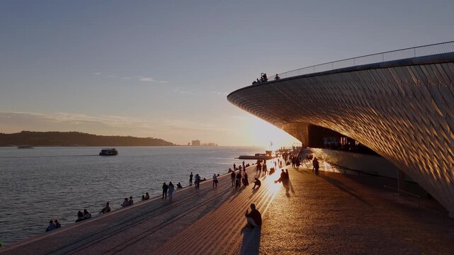 Aerial Rise Over MAAT Museum and Tagus River at Sunset in Lisbon