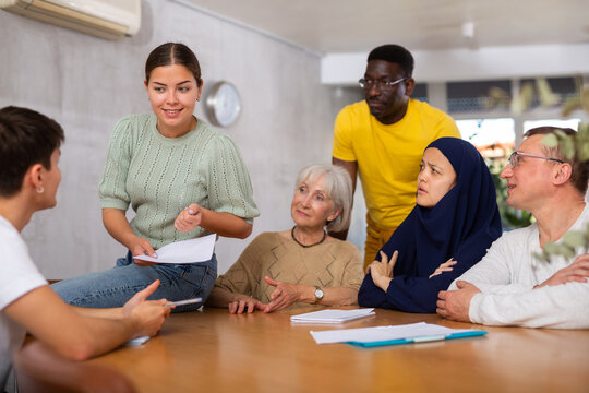 Group students different ages and multinational discussion during business course