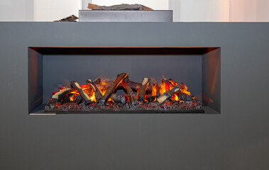 Wood burning in fireplace inside modern interior