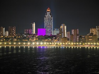 Fototapeta premium evening skyline highlights, night scene featuring illuminated structures and seaside reflections