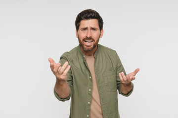 Fototapeta premium Head shot portrait dissatisfied man in casual frowning eyebrows having dissatisfied grumpy face expression posing over white studio background negative emotions irritated person concept image